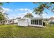 Spacious backyard with green grass, shed, and enclosed lanai, perfect for outdoor enjoyment at 250 Douglas Dr, Eustis, FL 32726