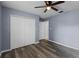 Bedroom with wood floors, ceiling fan, and a closet and attached bathroom at 250 Douglas Dr, Eustis, FL 32726