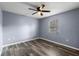 Cozy bedroom with wood flooring, ceiling fan, and a window for natural light at 250 Douglas Dr, Eustis, FL 32726