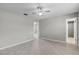 Bedroom with tile floors, ceiling fan, and a view into the bathroom at 250 Douglas Dr, Eustis, FL 32726