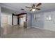 Open-concept living room with tile flooring, ceiling fan, and ample natural light at 250 Douglas Dr, Eustis, FL 32726