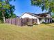 Exterior view of house showing the backyard, fence, and lawn area at 2600 Musselwhite Ave, Orlando, FL 32804