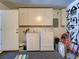 Bright laundry room featuring a washer, dryer, and ample storage space at 2600 Musselwhite Ave, Orlando, FL 32804