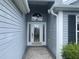 Beautiful front door with decorative glass, enhanced by the sidelight and transom window at 2628 Caribe Dr, The Villages, FL 32162