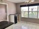 Eat-in kitchen features white tile floor, peninsula counter, and natural light at 2628 Caribe Dr, The Villages, FL 32162