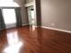 Spacious living room featuring gleaming hardwood floors and natural light from a large window at 2628 Caribe Dr, The Villages, FL 32162