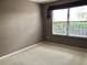 Cozy bedroom featuring a neutral color scheme, large window, and plush carpeting at 2628 Caribe Dr, The Villages, FL 32162