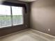 This bedroom features neutral colors and a large window, offering plenty of natural light at 2628 Caribe Dr, The Villages, FL 32162