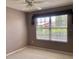 This bedroom features neutral colors and a large window, offering plenty of natural light at 2628 Caribe Dr, The Villages, FL 32162