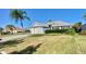Charming single Gathering home features a beautiful lawn, lovely landscaping, and attached two-car garage at 2628 Caribe Dr, The Villages, FL 32162