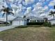 Single Gathering home featuring an attached garage and pristine landscaping under sunny and cloudy skies at 2628 Caribe Dr, The Villages, FL 32162