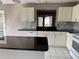 Bright kitchen features white cabinets, black countertops, and a spacious island perfect for meal prep at 2628 Caribe Dr, The Villages, FL 32162