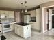 Traditional kitchen featuring white cabinets, black countertops, and updated appliances at 2628 Caribe Dr, The Villages, FL 32162