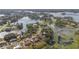 Overhead view of a lakeside neighborhood with houses surrounded by mature trees and serene water at 2662 Hibiscus Ct, Deltona, FL 32738