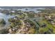 Scenic aerial view of homes nestled along a picturesque lake with lush greenery at 2662 Hibiscus Ct, Deltona, FL 32738