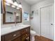 Bathroom features wood vanity with white countertop, single sink, wood floors, and a toilet at 2662 Hibiscus Ct, Deltona, FL 32738