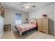 Bedroom features neutral decor, tiled floors, a ceiling fan, and plenty of natural light at 2662 Hibiscus Ct, Deltona, FL 32738