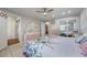 Spacious bedroom featuring tiled floors, ceiling fan, light walls, and mirrored closet doors at 2662 Hibiscus Ct, Deltona, FL 32738