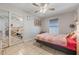 Relaxing bedroom features tile floors, ceiling fan, large mirrored closet doors, and neutral decor at 2662 Hibiscus Ct, Deltona, FL 32738