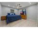 Tranquil bedroom with tiled floors, ceiling fan, natural light, and wooden furniture at 2662 Hibiscus Ct, Deltona, FL 32738