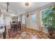 Dining area featuring stone tile floors, natural lighting, and a view to the front yard at 2662 Hibiscus Ct, Deltona, FL 32738