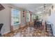 Dining area featuring stone tile floors, large windows, and natural lighting at 2662 Hibiscus Ct, Deltona, FL 32738