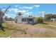 Exterior of house with an enclosed patio, palm trees, and a fenced yard at 2662 Hibiscus Ct, Deltona, FL 32738