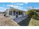 Exterior view of home, screened-in patio, and well-manicured landscaping at 2662 Hibiscus Ct, Deltona, FL 32738