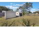 Two storage sheds reside on a verdant lot, and the property is surrounded by fencing at 2662 Hibiscus Ct, Deltona, FL 32738