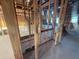 Hallway with exposed framing, plumbing, and electrical wiring visible at 30117 Misty Pines Rd, Mount Dora, FL 32757