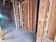 Unfinished room with exposed beams, wood framing and concrete floor, waiting for final touches at 30117 Misty Pines Rd, Mount Dora, FL 32757