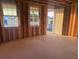 Unfinished room with exposed wood framing, windows, and a view of the outdoors, ready for customization at 30117 Misty Pines Rd, Mount Dora, FL 32757