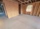 Unfinished room with exposed beams, wood framing and concrete floor, waiting for final touches at 30117 Misty Pines Rd, Mount Dora, FL 32757