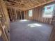 Spacious room showcasing the home's wooden framework and bright natural light from the windows at 30120 Misty Pines Rd, Mount Dora, FL 32757