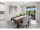 Cozy dining room with a wooden table, gray chairs, and sliding glass doors leading to the outside at 3029 Ambersweet Pl, Clermont, FL 34711