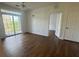 A bright bedroom featuring wood flooring, a ceiling fan and a glass door leading to an outdoor balcony at 3177 Feltrim Pl # 304, Kissimmee, FL 34747