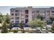 Exterior view of a condo building featuring multiple floors, balconies, and well-maintained landscaping and full parking lot at 3177 Feltrim Pl # 304, Kissimmee, FL 34747