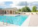 A refreshing community pool with comfortable lounge chairs and clubhouse in the background at 3177 Feltrim Pl # 304, Kissimmee, FL 34747