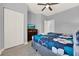 Bedroom with a view of TV, wardrobe, ceiling fan, and blue patterned comforter at 3204 Gold Ln, Kissimmee, FL 34747