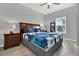 Bedroom with floral bedding, wood furniture, ceiling fan, and light wood flooring at 3204 Gold Ln, Kissimmee, FL 34747