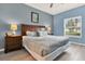 Bedroom with blue walls, wooden furniture, ceiling fan, and light colored wood flooring at 3204 Gold Ln, Kissimmee, FL 34747