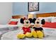 Bedroom with two twin beds featuring Mickey and Minnie Mouse plush toys at 3204 Gold Ln, Kissimmee, FL 34747