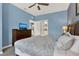 Bedroom with blue walls, wood dresser with TV, and view through doorway to kitchen at 3204 Gold Ln, Kissimmee, FL 34747