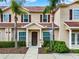 Attractive townhome exterior featuring well-maintained landscaping, a sidewalk, and inviting curb appeal at 3204 Gold Ln, Kissimmee, FL 34747