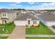 Aerial view of a well-maintained one-story home with a manicured lawn, two-car garage, and a welcoming entrance at 3871 Brant Pl, Leesburg, FL 34748