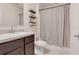 Bathroom with a single sink vanity, decorative shelves, and a shower with a patterned curtain at 3871 Brant Pl, Leesburg, FL 34748