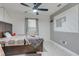 This bedroom features a ceiling fan, unique accent wall, and stylish flooring at 3871 Brant Pl, Leesburg, FL 34748