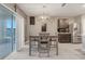 Bright dining area with sliding glass doors, adjacent to the kitchen, perfect for Gathering meals at 3871 Brant Pl, Leesburg, FL 34748