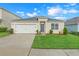 Welcoming one-story home with manicured lawn, two-car garage and inviting curb appeal in a residential neighborhood at 3871 Brant Pl, Leesburg, FL 34748