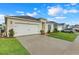 Charming single-story home features a two-car garage, well-manicured lawn, and inviting curb appeal at 3871 Brant Pl, Leesburg, FL 34748